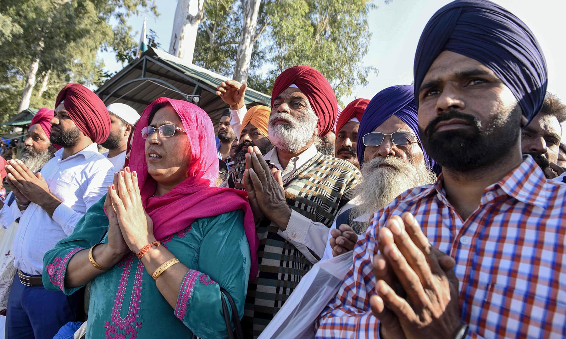 Sikh devotees offer prayers towards the shrine of Guru Nanak Dev Ji at Gurdwara Darbar Sahib.